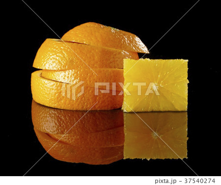 A stack of orange slices and a cube of fruit flesh A stack of orange slices and a cube of fruit flesh 37540274