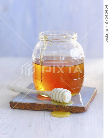 Jar of honey with honey dipper Jar of honey with honey dipper 37540404