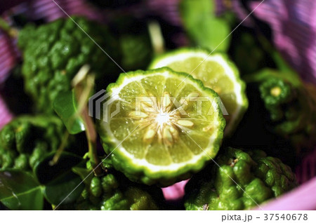 Thai limes with wrinkled skin, whole and halved 37540678