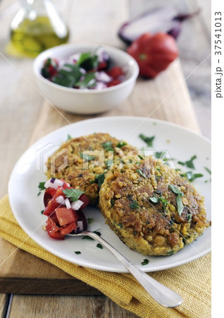 Pan-fried chickpea cakes spiced with cumin and coriander with fresh tomato salsa Pan-fried chickpea cakes spiced with cumin and coriander with fresh tomato salsa 37541013