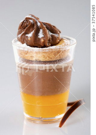 A layered dessert made with oranges and chocolate cream, biscuits and hazelnut ganache A layered dessert made with oranges and chocolate cream, biscuits and hazelnut ganache 37541085