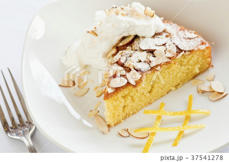 Citrus Olive Oil Cake Topped with Almonds and Whipped Cream 37541278