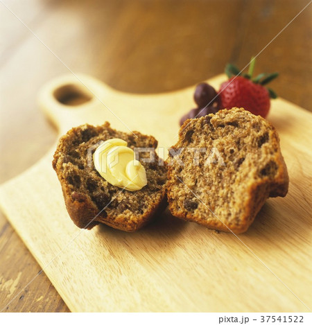 Raisin Bran Muffin Halved with Butter 37541522