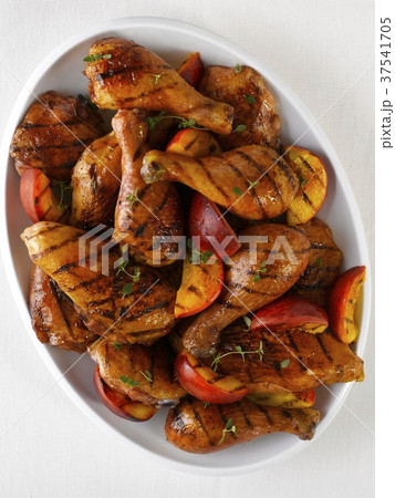 Grilled Chicken Pieces with a Peach Mango Glaze and Fresh Grilled Peaches 37541705