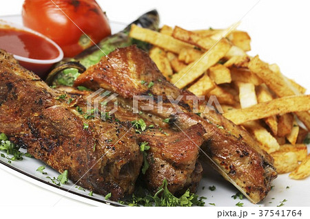 Pork Ribs with Fresh Parsley and French Fries Pork Ribs with Fresh Parsley and French Fries 37541764