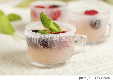 Pink Lemonade Spritzer with Fresh Berries in Small Glasses Pink Lemonade Spritzer with Fresh Berries in Small Glasses 37541980