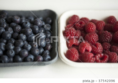 Blueberries and raspberries in bowls Blueberries and raspberries in bowls 37542096