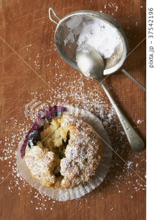 A fresh blueberry muffin with a bite taken out A fresh blueberry muffin with a bite taken out 37542196