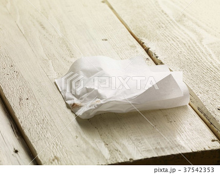 A piece of screwed up paper with a dollop of ketchup A piece of screwed up paper with a dollop of ketchup 37542353