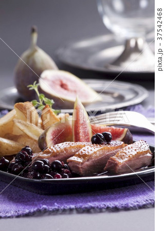 Duck breast with roast potatoes, figs and berry compote 37542468