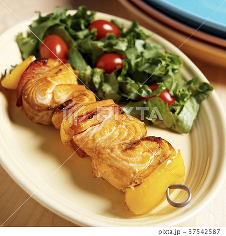 Salmon Kabob Red and Yellow Bell Peppers on a Metal Skewer; Side Salad 37542587