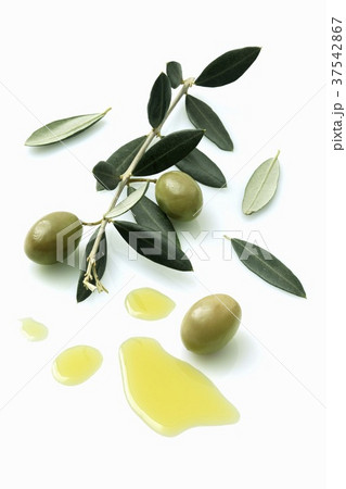 A olive sprig with olives next to a pool of olive oil A olive sprig with olives next to a pool of olive oil 37542867