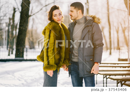 happy couple walking through the park on a sunny happy couple walking through the park on a sunny 37543406