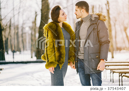 happy couple walking through the park on a sunny 37543407