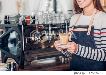 asia woman barista holding hot coffee cup served 37548262