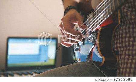 Young male musician composes and records 37555099
