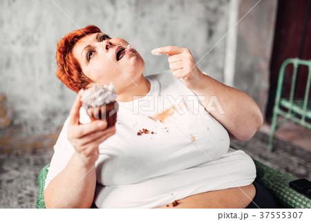 Overweight woman eats sweet cake, obesity 37555307