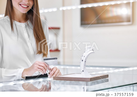 Smiling woman near the counter in a jewelry shop 37557159