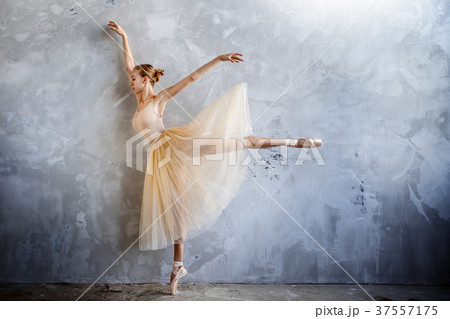 Young ballerina in golden costume posing in studio Young ballerina in golden costume posing in studio 37557175