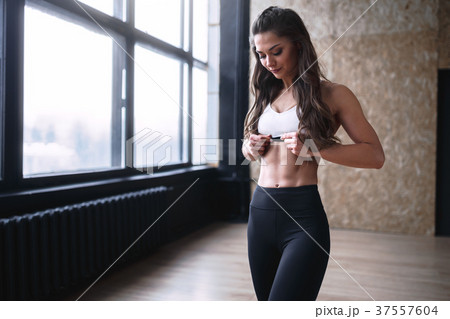 Female fitness model in white top and black pants Female fitness model in white top and black pants 37557604