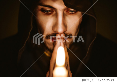 a monk with a candle 37559534