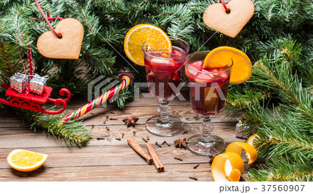 Two glasses of hot mulled wine with oranges 37560907