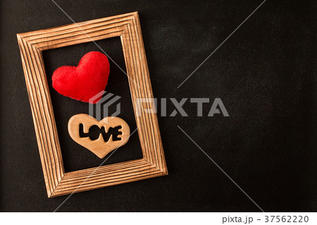 Heart in wooden  picture frame on the chalkboard 37562220