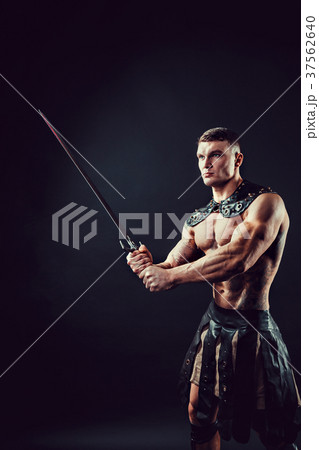 Severe barbarian in leather costume with sword 37562640