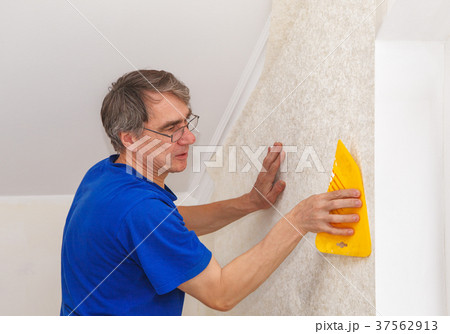 elderly worker smoothing wallpaper elderly worker smoothing wallpaper 37562913