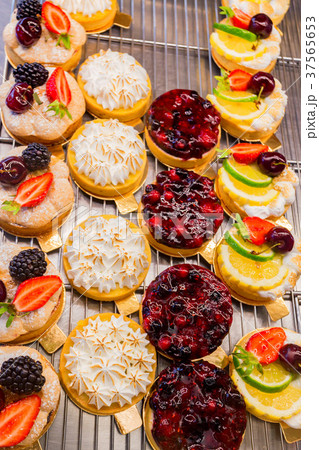 Dessert tartlets with fruit and berries top view Dessert tartlets with fruit and berries top view 37565653