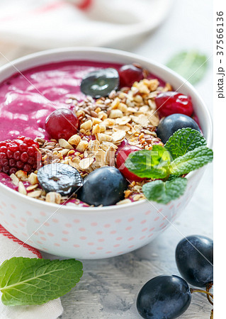 Smoothie bowl with red beets and black grapes. 37566136