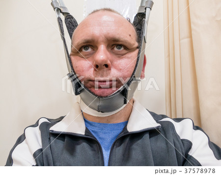 Man in neck traction machine 37578978