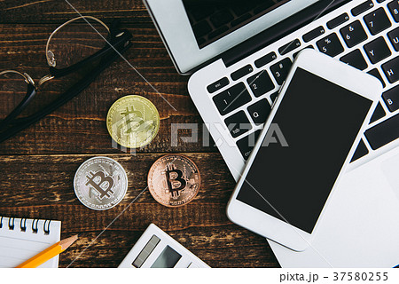 bitcoin and computer on wooden table 37580255