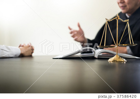 business people and lawyers discussing contract papers sitting a business people and lawyers discussing contract papers sitting a 37586420