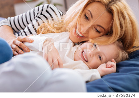 Inspired mother lying with her daughter 37590374