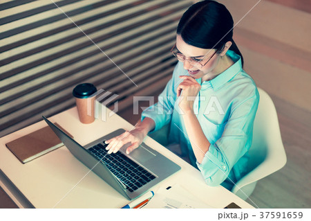 Top view of pleasant woman proofreading her report 37591659