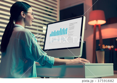 Smiling female analyst creating graphs and Smiling female analyst creating graphs and 37591682