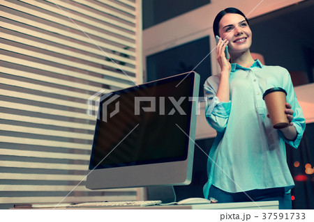 Charming woman talking on the phone and having Charming woman talking on the phone and having 37591733