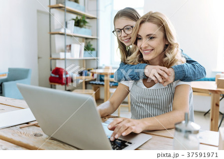 Positive delighted females looking at computer 37591971