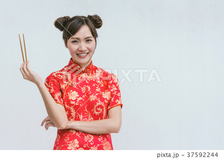 Young Chinese woman holding chopsticks 37592244