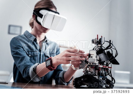 Competent woman testing new gadget Competent woman testing new gadget 37592693
