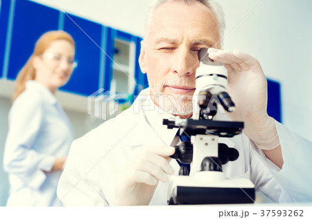Positive minded researcher looking at sample under Positive minded researcher looking at sample under 37593262
