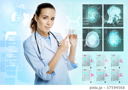 Calm doctor pointing to a pillbox while holding it 37594568