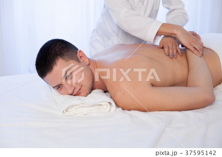 male masseur doing massage back spa health male masseur doing massage back spa health 37595142