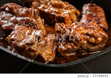 Pork spare ribs on dish in own sauce 37596045