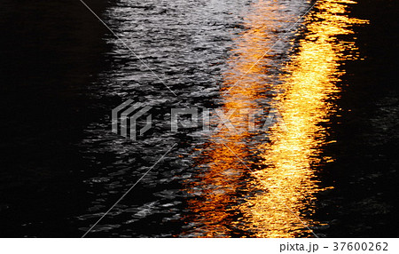 blurry of artificial light pole on canal in night 37600262