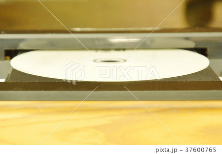 DVD put on insert disc player in wooden cupboard 37600765