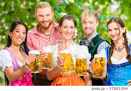 Friends in beer garden with beer glasses Friends in beer garden with beer glasses 37601304