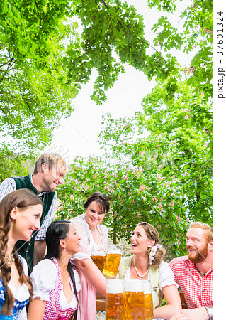Waitress serving beer in beer garden 37601324