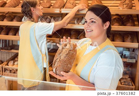 Two salesladies selling bread and other products Two salesladies selling bread and other products 37601382